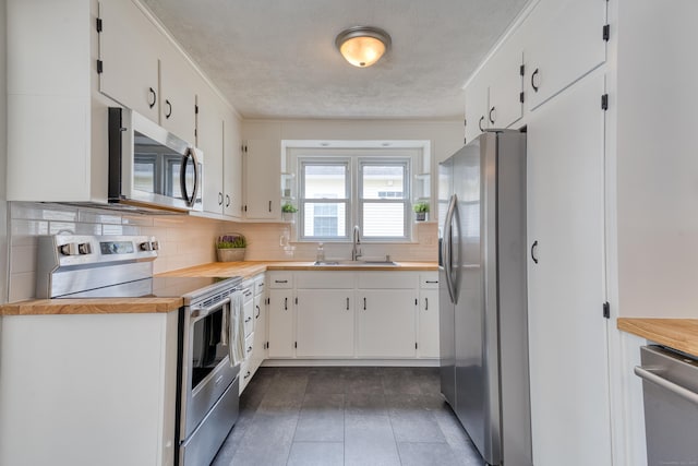 226 Farm Hill Rd, Middletown, CT 06457 - kitchen featuring appliances with stainless steel finishes, tasteful backsplash, ornamental molding, white cabinets, and a textured ceiling
