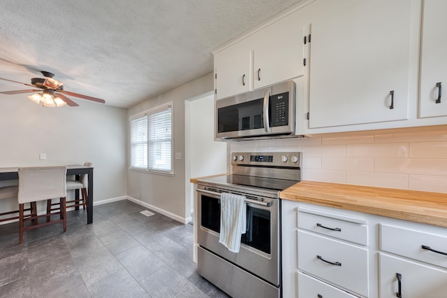 226 Farm Hill Rd, Middletown, CT 06457 - kitchen with stainless steel appliances, decorative backsplash, a textured ceiling, ceiling fan, and white cabinets