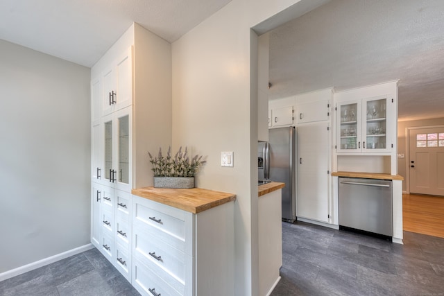 226 Farm Hill Rd, Middletown, CT 06457 - kitchen featuring butcher block countertops, stainless steel appliances, glass insert cabinets, and white cabinets