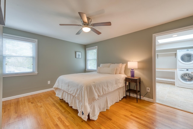 226 Farm Hill Rd, Middletown, CT 06457 - bedroom featuring stacked washer / drying machine, light wood-style flooring, and a ceiling fan