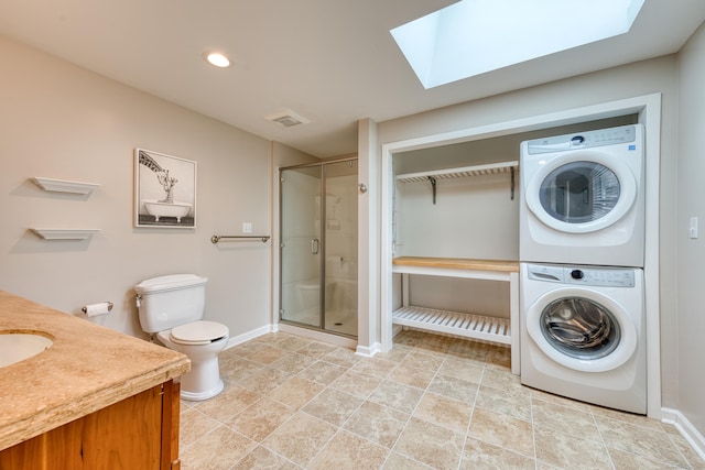 226 Farm Hill Rd, Middletown, CT 06457 - full bathroom with stacked washer and clothes dryer, a skylight, a stall shower, vanity, and recessed lighting
