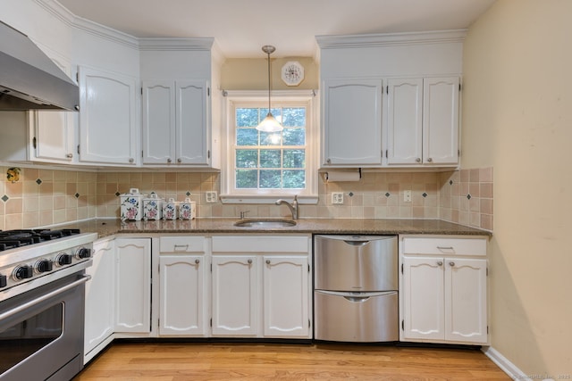 20 Copper Hill Dr Unit 20, Guilford, CT 06437 - kitchen featuring appliances with stainless steel finishes, wall chimney exhaust hood, white cabinetry, light wood-style flooring, and pendant lighting