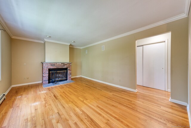 20 Copper Hill Dr Unit 20, Guilford, CT 06437 - unfurnished living room featuring light wood finished floors, crown molding, a brick fireplace, and baseboard heating