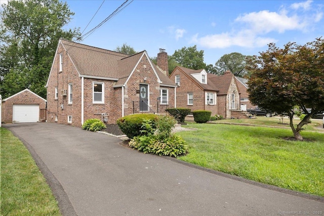 30 Cedar Crest Pl, Norwalk, CT 06854 - view of front of house featuring an outdoor structure, a detached garage, brick siding, a chimney, and asphalt driveway