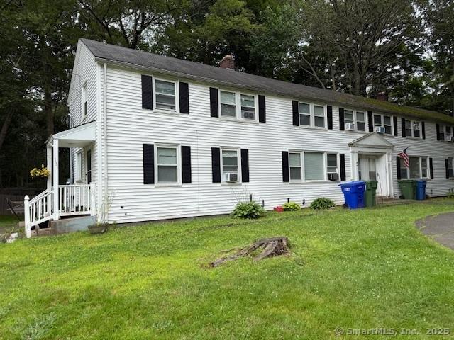 131 N Ridgeland Rd, Wallingford, CT 06492 - colonial inspired home featuring a front yard, cooling unit, and view of scattered trees