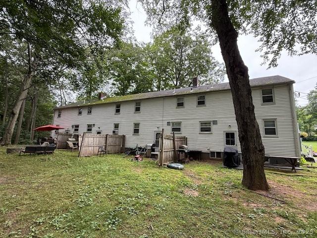 131 N Ridgeland Rd, Wallingford, CT 06492 - rear view of house featuring a lawn and a chimney