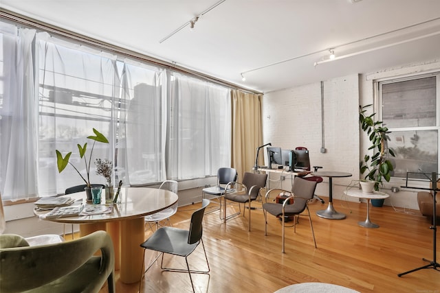 817 Grand Ave Unit 202, New Haven, CT 06511 - dining space featuring track lighting, wood finished floors, and brick wall