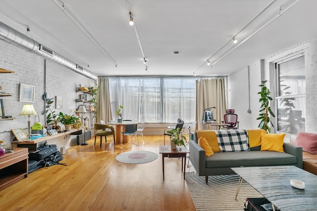817 Grand Ave Unit 202, New Haven, CT 06511 - living room featuring rail lighting, wood finished floors, plenty of natural light, and brick wall