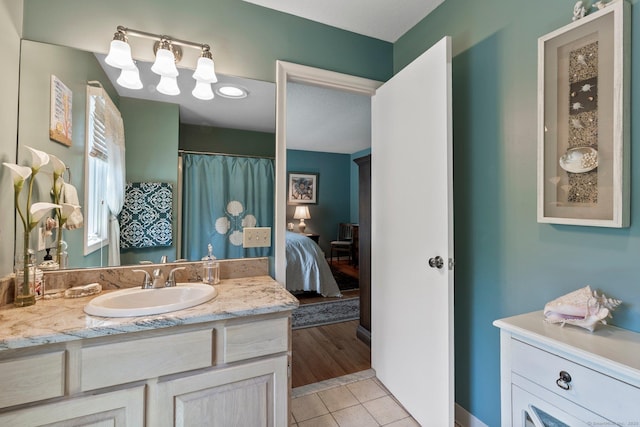 ensuite bathroom with vanity and tile patterned floors