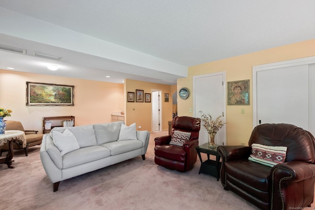 living area with light carpet and recessed lighting