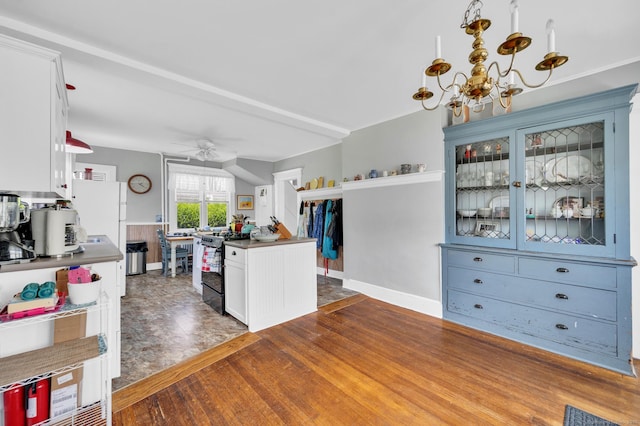 159 Jefferson St, Stratford, CT 06615 - kitchen with black stove, a chandelier, white cabinets, ceiling fan, and glass insert cabinets