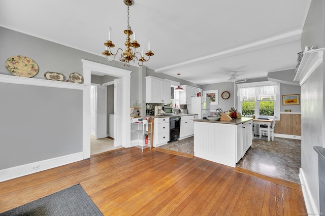 159 Jefferson St, Stratford, CT 06615 - kitchen featuring black dishwasher, freestanding refrigerator, a chandelier, white cabinetry, and hardwood / wood-style floors