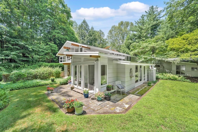 12 Twin Ponds Dr, Farmington, CT 06085 - view of property exterior with a sunroom, a patio, and a lawn