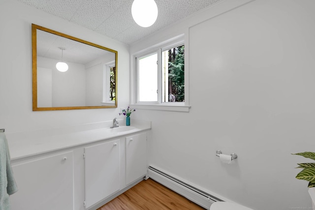 12 Twin Ponds Dr, Farmington, CT 06085 - bathroom with baseboard heating, vanity, and wood finished floors