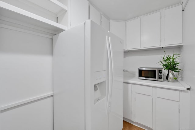 12 Twin Ponds Dr, Farmington, CT 06085 - kitchen with white fridge with ice dispenser, stainless steel microwave, light countertops, and white cabinetry