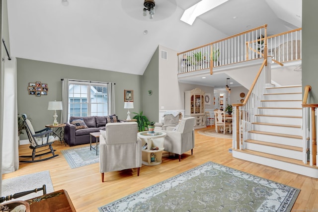 6 Augusta Cir Unit 6, East Haddam, CT 06469 - living room with high vaulted ceiling, a skylight, wood finished floors, stairs, and a ceiling fan