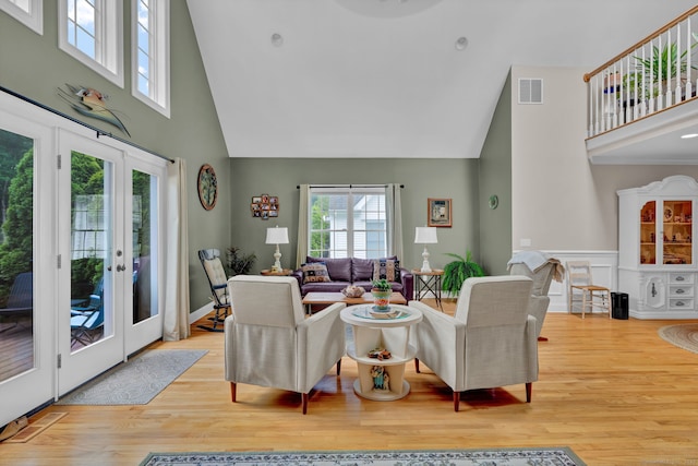 6 Augusta Cir Unit 6, East Haddam, CT 06469 - living room featuring high vaulted ceiling, french doors, wood finished floors, and wainscoting