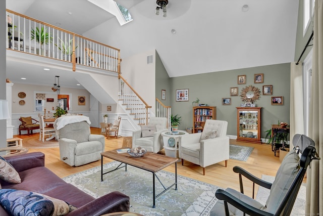 6 Augusta Cir Unit 6, East Haddam, CT 06469 - living area with high vaulted ceiling, stairs, a skylight, wood finished floors, and a ceiling fan