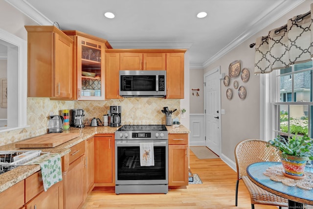 6 Augusta Cir Unit 6, East Haddam, CT 06469 - kitchen with stainless steel appliances, crown molding, light wood-type flooring, tasteful backsplash, and light stone countertops