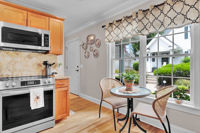 6 Augusta Cir Unit 6, East Haddam, CT 06469 - kitchen with stainless steel appliances, decorative backsplash, ornamental molding, light wood finished floors, and light brown cabinetry