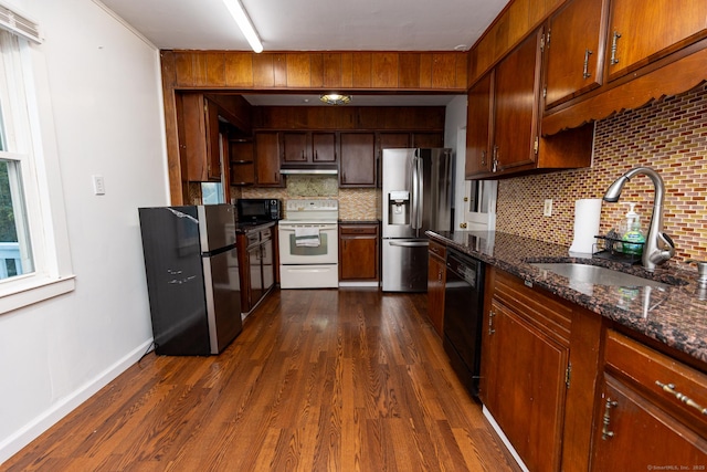 302 E Pasadena Pl, Bridgeport, CT 06610 - kitchen with black appliances, under cabinet range hood, backsplash, dark wood-type flooring, and dark stone countertops