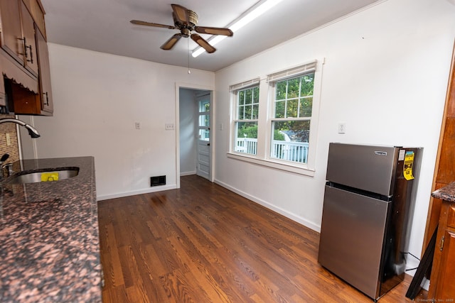 302 E Pasadena Pl, Bridgeport, CT 06610 - kitchen featuring freestanding refrigerator, dark wood finished floors, ceiling fan, and dark stone countertops