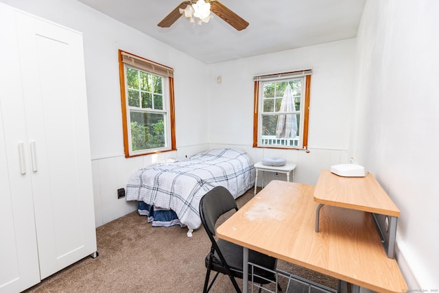 302 E Pasadena Pl, Bridgeport, CT 06610 - carpeted bedroom with wainscoting and ceiling fan