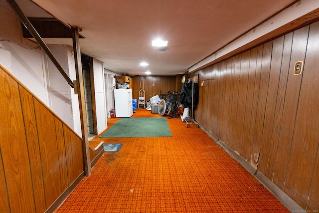 302 E Pasadena Pl, Bridgeport, CT 06610 - finished basement with wooden walls, white refrigerator, and light carpet