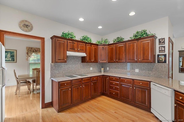 92 Tyler City Rd, Orange, CT 06477 - kitchen featuring white dishwasher, under cabinet range hood, black electric cooktop, light wood-style floors, and decorative backsplash