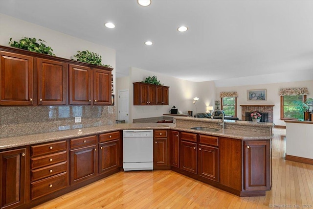 92 Tyler City Rd, Orange, CT 06477 - kitchen with white dishwasher, light wood-style flooring, open floor plan, decorative backsplash, and a peninsula