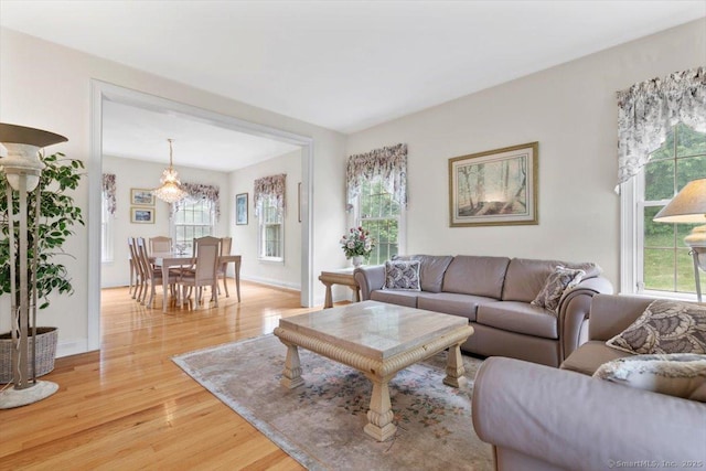 92 Tyler City Rd, Orange, CT 06477 - living area with light wood-type flooring and a chandelier