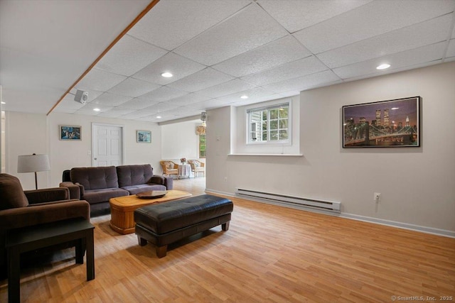 92 Tyler City Rd, Orange, CT 06477 - living area with a baseboard radiator, light wood-style flooring, a paneled ceiling, and recessed lighting