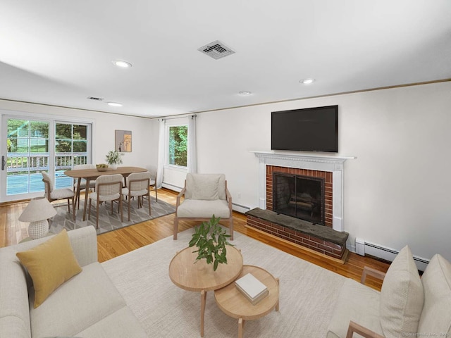7 Ambler Rd W, Westport, CT 06880 - living room featuring a baseboard radiator, a brick fireplace, recessed lighting, and wood finished floors