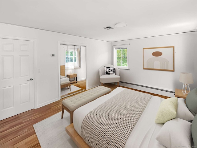 7 Ambler Rd W, Westport, CT 06880 - bedroom with a baseboard heating unit, wood finished floors, and multiple windows