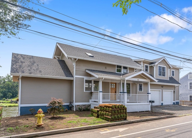 281 E Ave, Norwalk, CT 06850 - view of front of home with covered porch, driveway, a garage, and roof with shingles