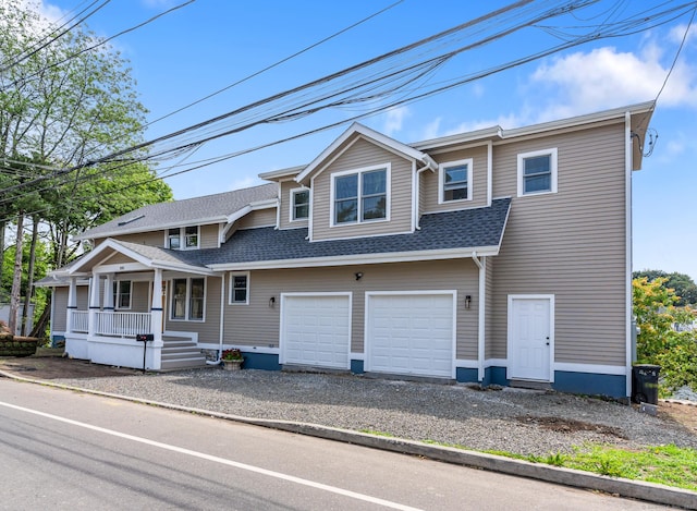 281 E Ave, Norwalk, CT 06850 - townhome / multi-family property with covered porch, gravel driveway, roof with shingles, and an attached garage