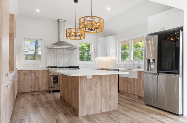 281 E Ave, Norwalk, CT 06850 - kitchen with stainless steel appliances, wall chimney exhaust hood, modern cabinets, a chandelier, and tasteful backsplash