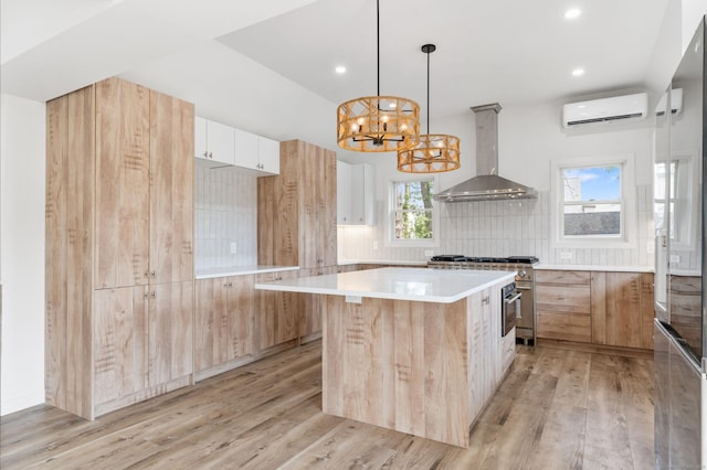 281 E Ave, Norwalk, CT 06850 - kitchen with ventilation hood, a wall mounted air conditioner, a chandelier, light wood-type flooring, and recessed lighting