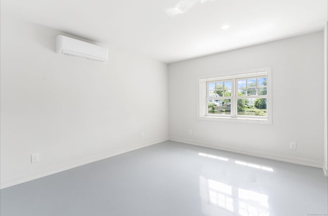 281 E Ave, Norwalk, CT 06850 - unfurnished room with a wall mounted air conditioner, concrete flooring, and recessed lighting