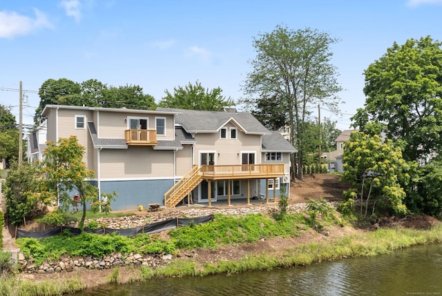 281 E Ave, Norwalk, CT 06850 - back of property featuring stairs, a deck with water view, and roof with shingles