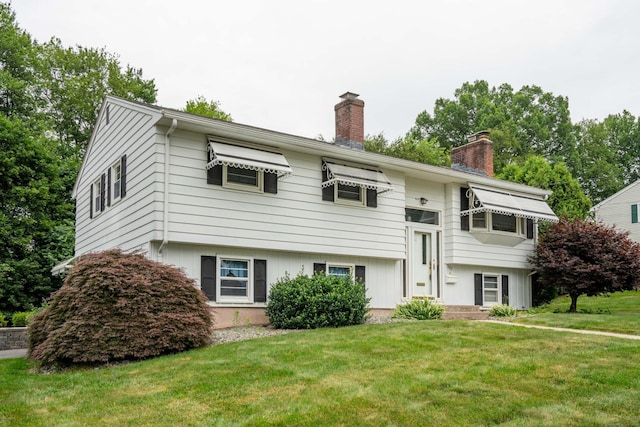102 Herbert Dr, East Hartford, CT 06118 - bi-level home with a chimney and a front yard