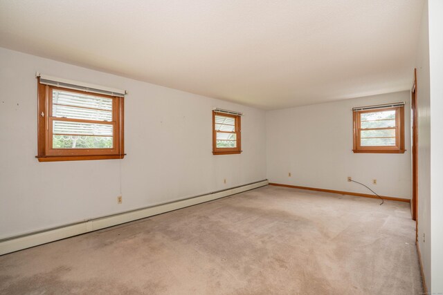 102 Herbert Dr, East Hartford, CT 06118 - empty room with baseboard heating, plenty of natural light, and carpet flooring