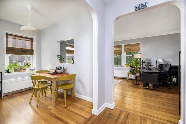 132 Summer St Unit 3C, Stamford, CT 06614 - dining space with hardwood / wood-style flooring, arched walkways, and a desk