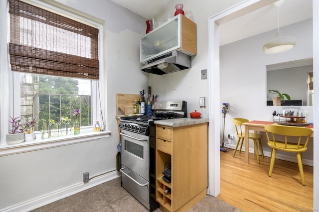 132 Summer St Unit 3C, Stamford, CT 06614 - kitchen featuring gas range, custom range hood, light countertops, and hanging light fixtures