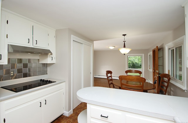 109 Pinnacle Rd, Ellington, CT 06029 - kitchen with a baseboard radiator, under cabinet range hood, decorative backsplash, black electric cooktop, and light countertops