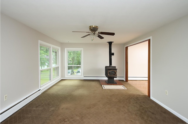 109 Pinnacle Rd, Ellington, CT 06029 - unfurnished living room with baseboard heating, carpet flooring, a baseboard heating unit, a wood stove, and ceiling fan