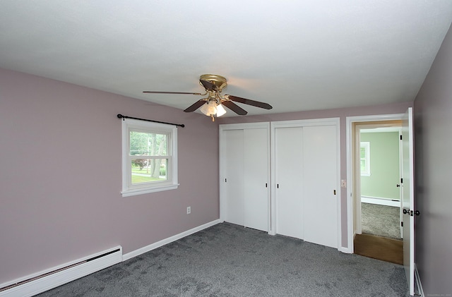 109 Pinnacle Rd, Ellington, CT 06029 - unfurnished bedroom featuring a baseboard radiator, multiple closets, dark carpet, and ceiling fan