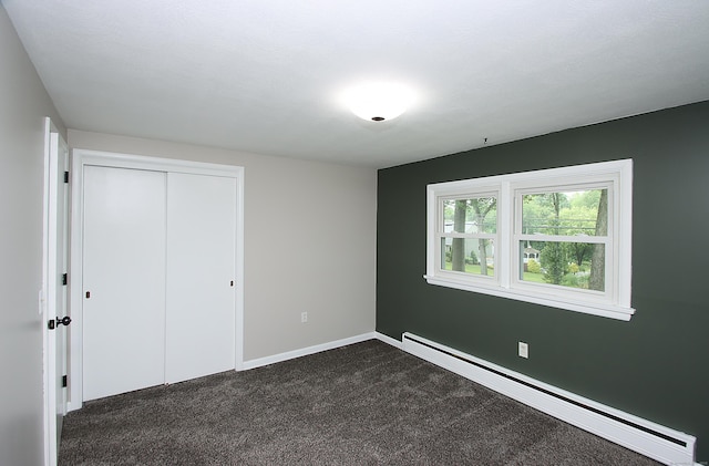 109 Pinnacle Rd, Ellington, CT 06029 - unfurnished bedroom with a baseboard heating unit, dark colored carpet, and a closet