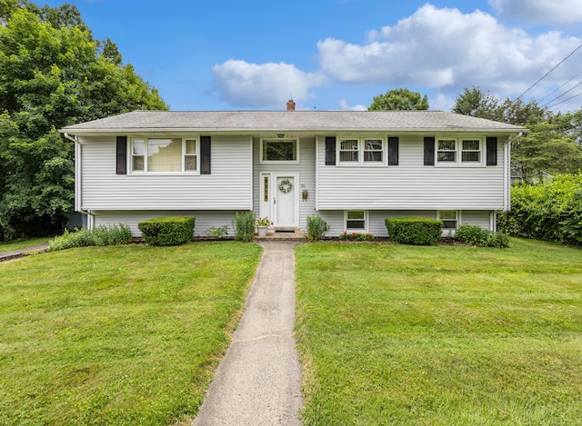 95 Flagg Ave, Watertown, CT 06779 - split foyer home featuring a front yard and a chimney