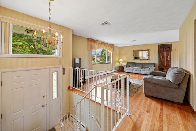 95 Flagg Ave, Watertown, CT 06779 - entryway with a chandelier, wood finished floors, and baseboard heating